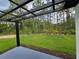 Outdoor space with a covered pergola and a serene view of the wooded landscape at 42157 Tamarac St, Eustis, FL 32736