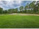 Expansive backyard with lush green grass and mature trees, offering ample space at 42157 Tamarac St, Eustis, FL 32736