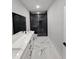 Bathroom featuring marble floors, dual sinks, and a glass enclosed shower with intricate tile at 42157 Tamarac St, Eustis, FL 32736