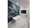 Modern bathroom featuring a freestanding tub, beautiful marble floors, and a unique blue tiled accent wall at 42157 Tamarac St, Eustis, FL 32736