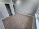 Neutral bedroom features carpeted floors, base trim and a window at 42157 Tamarac St, Eustis, FL 32736