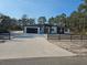 Modern two-story home with a large driveway and a fenced yard at 42157 Tamarac St, Eustis, FL 32736