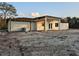 Lovely home exterior features a partially covered outdoor kitchen with sink at 42157 Tamarac St, Eustis, FL 32736