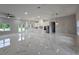 Open-concept kitchen and living space with stainless steel appliances and marble-look flooring at 42157 Tamarac St, Eustis, FL 32736