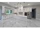 Modern kitchen with a large island, stainless steel appliances, and marble-look flooring at 42157 Tamarac St, Eustis, FL 32736