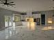 Bright, open-concept kitchen with marble floors, white cabinets, and stainless appliances at 42157 Tamarac St, Eustis, FL 32736