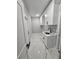 Clean laundry room featuring white cabinets, modern fixtures, and elegant marble-look tile flooring at 42157 Tamarac St, Eustis, FL 32736