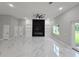 Modern living room featuring a dark accent wall and ample space at 42157 Tamarac St, Eustis, FL 32736