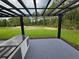 Outdoor patio with a black pergola and a built in countertop bar overlooking a grassy yard at 42157 Tamarac St, Eustis, FL 32736