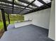 Covered patio featuring a black pergola and a granite countertop bar with sink at 42157 Tamarac St, Eustis, FL 32736