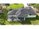 Beautiful aerial view of a modern home with a pergola and well-manicured lawn at 42200 Chinaberry St, Eustis, FL 32736