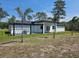 This home includes a covered patio and outdoor kitchen perfect for outdoor entertaining at 42200 Chinaberry St, Eustis, FL 32736
