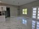 Bright dining room with marble floors, white framed windows, and a modern light fixture at 42200 Chinaberry St, Eustis, FL 32736