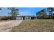 New home featuring a light gray color scheme, minimalist windows, a lawn, and attached two car garage at 42200 Chinaberry St, Eustis, FL 32736
