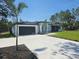 Beautiful one-story home featuring a two car garage, modern architecture, and a well-manicured lawn at 42200 Chinaberry St, Eustis, FL 32736
