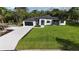 Charming home with a manicured lawn, modern design, and inviting curb appeal at 42200 Chinaberry St, Eustis, FL 32736