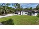 Beautiful modern home with a well manicured lawn and a concrete driveway leading to the garage at 42200 Chinaberry St, Eustis, FL 32736