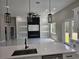 Living room with marble floors, modern light fixtures, fireplace, and built in shelving at 42200 Chinaberry St, Eustis, FL 32736