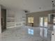 Spacious living room featuring built-in shelves, a ceiling fan and luxury marble floors at 42200 Chinaberry St, Eustis, FL 32736