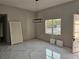 A neutral room features a stylish light fixture and luxury marble flooring at 42200 Chinaberry St, Eustis, FL 32736