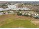 Community overview featuring homes, green spaces and a scenic lake at 5004 Saint Andrews Arc, Leesburg, FL 34748