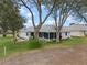 Home's exterior showcasing a screened patio and yard at 5004 Saint Andrews Arc, Leesburg, FL 34748