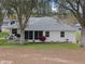 Home's exterior showcasing a screened patio and yard at 5004 Saint Andrews Arc, Leesburg, FL 34748