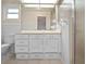 Clean bathroom with white vanity, toilet and shower at 5004 Saint Andrews Arc, Leesburg, FL 34748