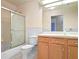 Simple bathroom with shower/tub combo and wood vanity at 5004 Saint Andrews Arc, Leesburg, FL 34748