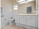 Bathroom with white vanity, toilet and shower at 5004 Saint Andrews Arc, Leesburg, FL 34748