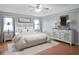 Bright bedroom with wood floors, large bed, and plenty of storage at 5004 Saint Andrews Arc, Leesburg, FL 34748