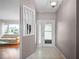 Bright entryway with a view into living room and decorative columns at 5004 Saint Andrews Arc, Leesburg, FL 34748