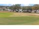 View of a putting green with residential houses visible in the distance at 5004 Saint Andrews Arc, Leesburg, FL 34748