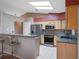 Modern kitchen with stainless steel appliances and breakfast bar at 5004 Saint Andrews Arc, Leesburg, FL 34748