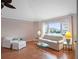 Relaxing living room featuring large windows and hardwood floors at 5004 Saint Andrews Arc, Leesburg, FL 34748