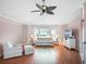 Spacious living room featuring hardwood floors, a large window, and comfortable seating at 5004 Saint Andrews Arc, Leesburg, FL 34748