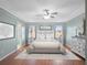 Spacious main bedroom with hardwood floors and ceiling fan at 5004 Saint Andrews Arc, Leesburg, FL 34748