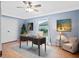 Home office with desk, chair, and ample natural light at 5004 Saint Andrews Arc, Leesburg, FL 34748