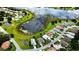 A scenic aerial view of a lakeside community with well-maintained homes and lush greenery at 5622 King James Ave, Leesburg, FL 34748