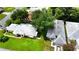 An aerial perspective of the home shows its landscaped yard, mature trees, and proximity to neighboring homes at 5622 King James Ave, Leesburg, FL 34748