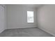 Simple bedroom with neutral wall color and carpet flooring at 5622 King James Ave, Leesburg, FL 34748