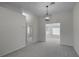 Bright dining room with gray carpet, chandelier, and access to other rooms at 5622 King James Ave, Leesburg, FL 34748