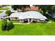 Well-maintained single-story home featuring a manicured lawn, neutral paint, and mature landscaping at 5622 King James Ave, Leesburg, FL 34748