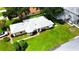 Attractive single-story home featuring a lush green lawn, mature trees, and well-maintained landscaping at 5622 King James Ave, Leesburg, FL 34748