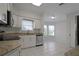 Kitchen with granite counters, white cabinets, and stainless steel appliances at 5622 King James Ave, Leesburg, FL 34748