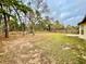 Large backyard with grassy area and wooden fence at 61 Fir Dr, Ocala, FL 34472