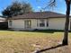 House back exterior with patio and large yard at 61 Fir Dr, Ocala, FL 34472