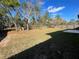 Large fenced backyard with patio and mature trees at 61 Fir Dr, Ocala, FL 34472