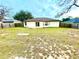 Large backyard with grassy area and wooden fence at 61 Fir Dr, Ocala, FL 34472