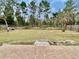 Fenced backyard with a patio and mature trees at 61 Fir Dr, Ocala, FL 34472